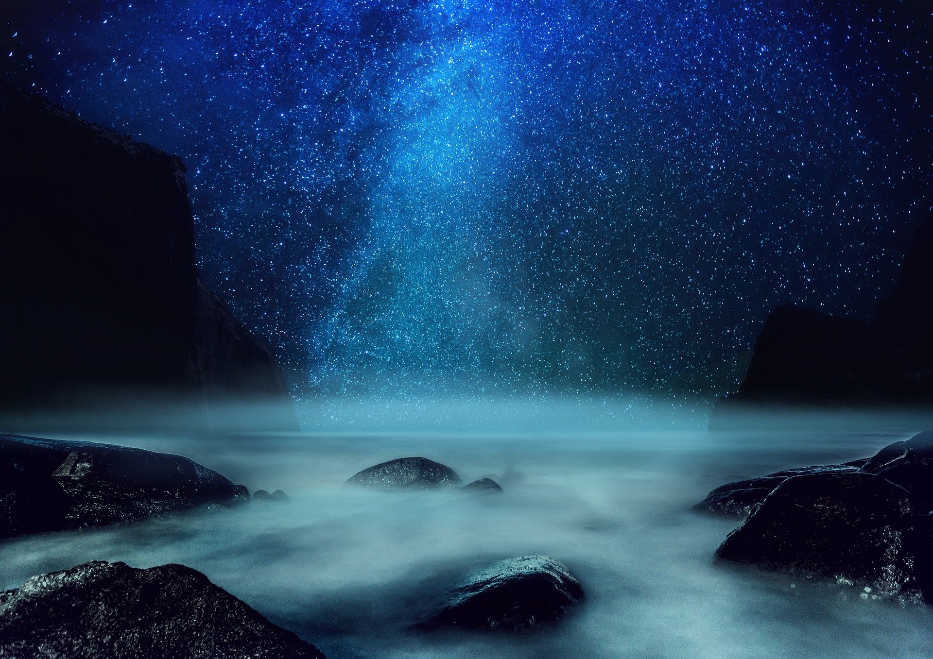 night sky with stars, water, mist and  rocks