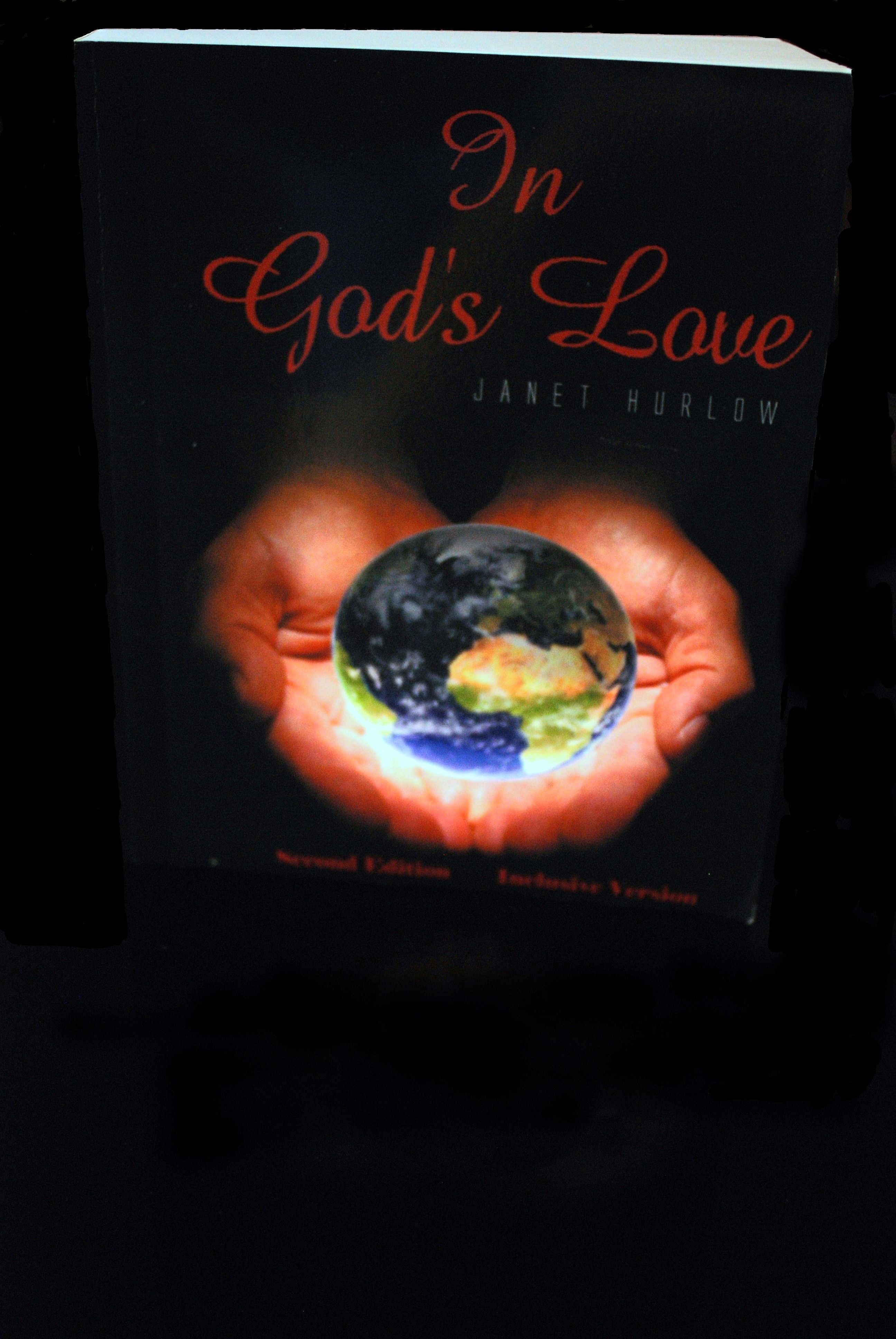 3-D book image see pages title In God's Love Second Edition Inclusive Version two hands holding the world